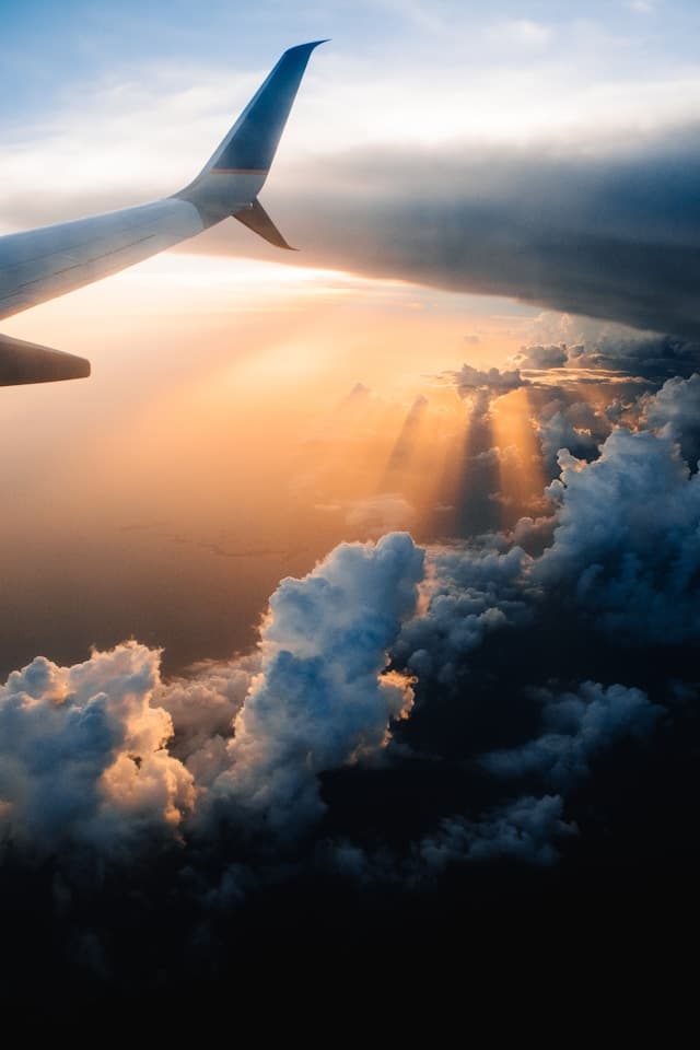 View from airplane in sky during golden hour